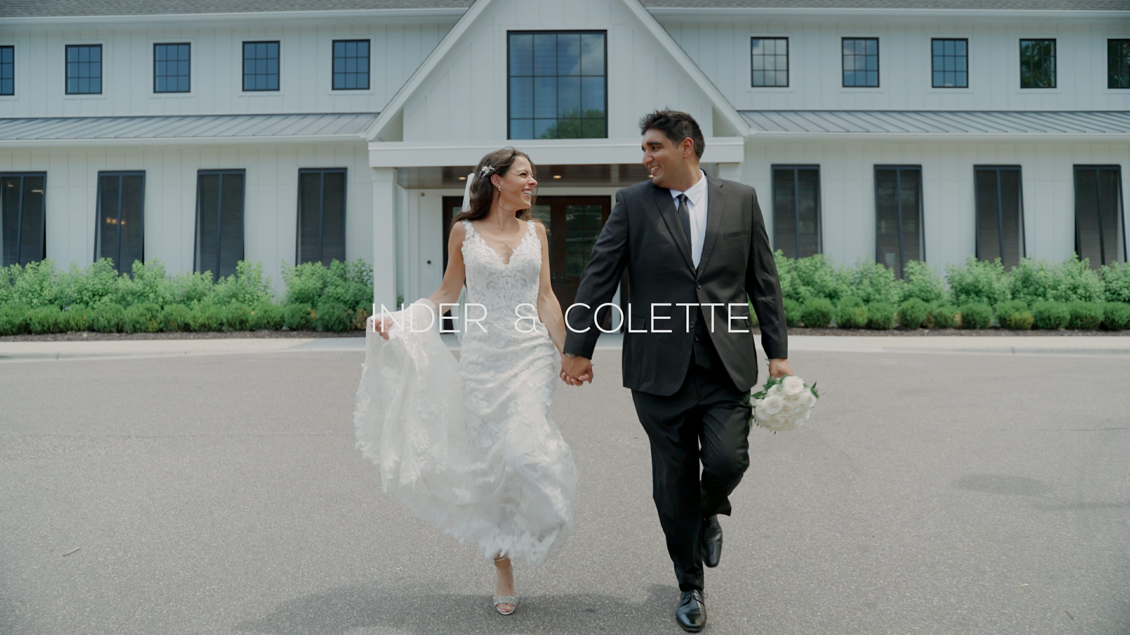 A groom and bride walking in front of The Hutton House on their wedding day.