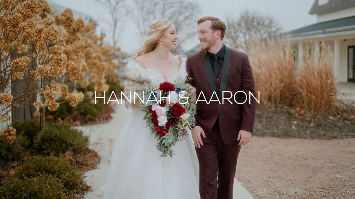 Bride and groom walking together while looking at eachother.